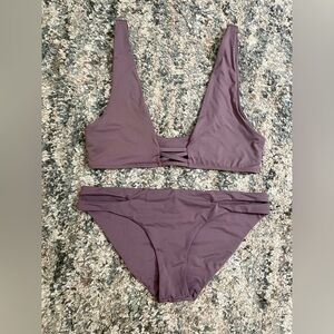 Dippin Daisy’s bikini- top is small and bottoms are medium. Lavender color.